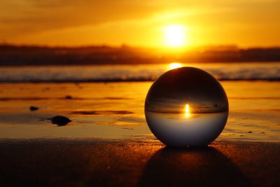 orb on beach with sunset in background